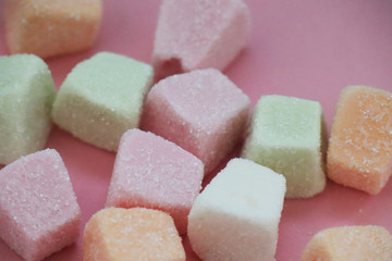 Colorful marshmallows on pink background
