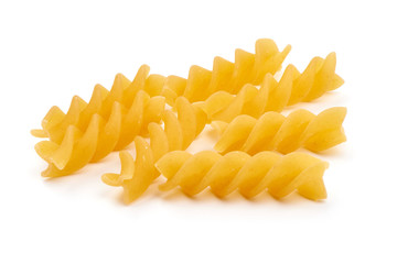 Raw fusilli pasta, close-up, isolated on white background