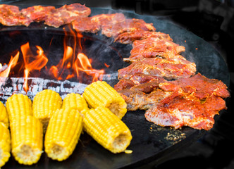 Corn on the cob on the fire ring grilled with open fire deliciously crispy