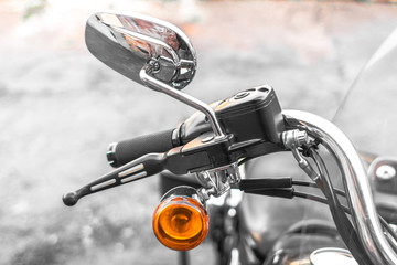 Classic chrome cruiser. Motorcycle handle. Front brake. The gas lever on the chopper. Speed dialing. Details of the motorcycle close-up. Part of the biker steering. Front turn signal.
