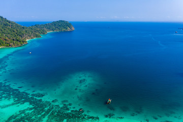 Fototapeta na wymiar Aerial drone view of a beautiful tropical island surrounded by coral reef (Greater Swinton Island, Myanmar)