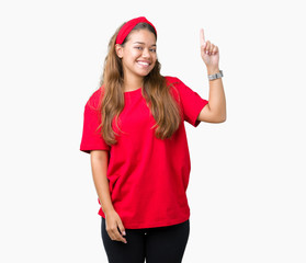 Obraz na płótnie Canvas Young beautiful brunette woman wearing red t-shirt over isolated background pointing finger up with successful idea. Exited and happy. Number one.