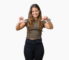 Young beautiful brunette woman over isolated background looking confident with smile on face,...