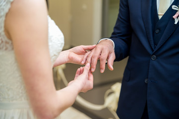 Obraz na płótnie Canvas Wedding rings. The bride wears a wedding ring on the groom.