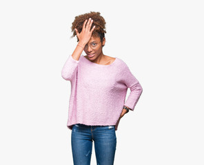 Beautiful young african american woman wearing glasses over isolated background surprised with hand on head for mistake, remember error. Forgot, bad memory concept.