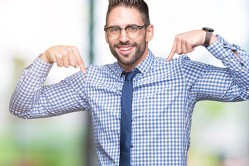 Young business man wearing glasses over isolated background looking confident with smile on face,...
