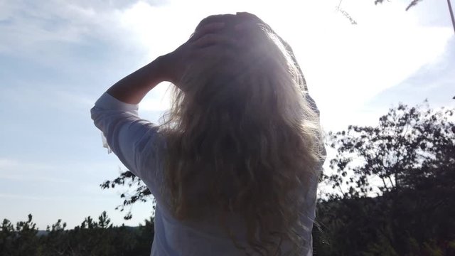 Beautiful happy girl woman playing with her blonde hair in sunset. 4K 