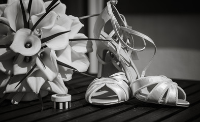 Wedding day shoes and flowers close up black and white