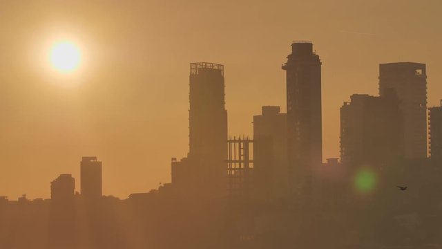 Sunset on the background of Mumbai skyscrapers. View from Chowpatty Beach.