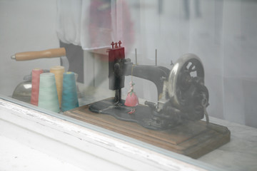 Store Window of a Tailor Shop, Antique Sewing Machine