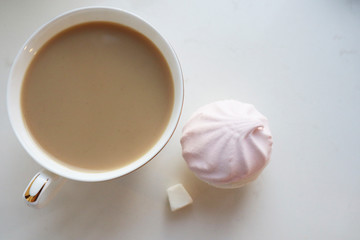 Still life. Coffee with milk and sweets on a white background.