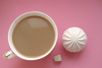 Still life. Coffee with milk and sweets on a pink background.