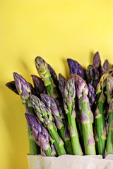 Green asparagus on yellow background