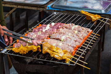 Grilled kebab cooking on metal skewer. Roasted meat cooked at barbecue. BBQ fresh beef meat chop slices.