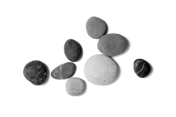 Fototapeta na wymiar Scattered sea pebbles. Smooth gray and black stones isolated on white background. Top view