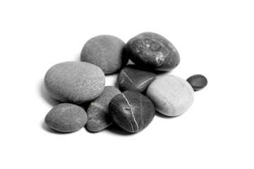Fototapeta na wymiar Scattered sea pebbles. Heap of smooth gray and black stones isolated on white background