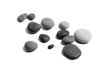 Scattered sea pebbles. Heap of smooth gray and black stones isolated on white background