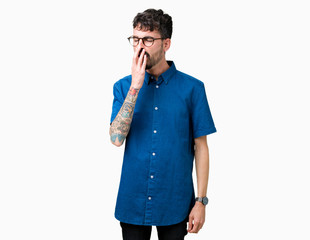 Fototapeta premium Young handsome man wearing glasses over isolated background bored yawning tired covering mouth with hand. Restless and sleepiness.