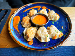 Polish dumplings - pierogi, on blue plate