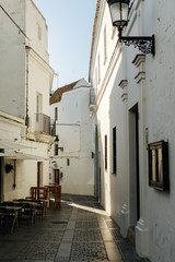 deep shadows on the cobblestone streets of vejer de la frontera in andalucia spain