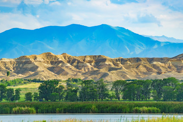 Lake with mountains in the background. Rest in Kyrgyzstan. Nature in the area of lake Issyk Kul.