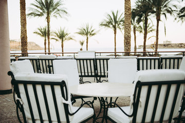 white chairs and table outdoor with sea view