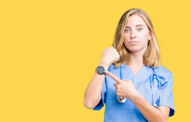 Beautiful young doctor woman wearing medical uniform over isolated background In hurry pointing to watch time, impatience, upset and angry for deadline delay