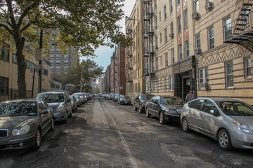 Beautiful landscape view of one of one of streets in Brighton beach neighborhood. Yellow buildnings and parked cars. Beautiful landscape backgrounds.