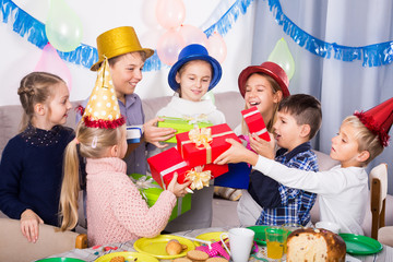 Cheerful children presenting gifts to girl  birthday