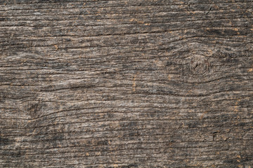 Fototapeta premium Rough brown wood texture background with horizontal grain and dark lines.