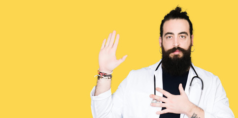 Doctor with long hair wearing medical coat and stethoscope Swearing with hand on chest and open...