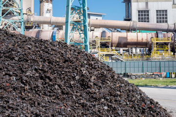 Huge pile of shredded tires used as alternative fuel in rotary kiln in cement plant