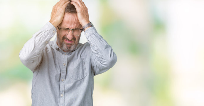Handsome middle age elegant senior man wearing glasses over isolated background suffering from headache desperate and stressed because pain and migraine. Hands on head.