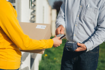 woman paying with debit card for delivery service