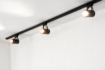 Spotlights under the ceiling on the wall. Track LED-lighting system