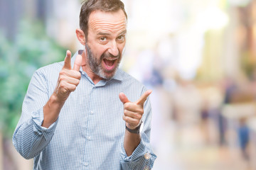 Obraz premium Middle age hoary senior business man over isolated background pointing fingers to camera with happy and funny face. Good energy and vibes.