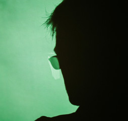 Abstract background shadow of pensive male head wearing eyewear glasses on digital wall light from...