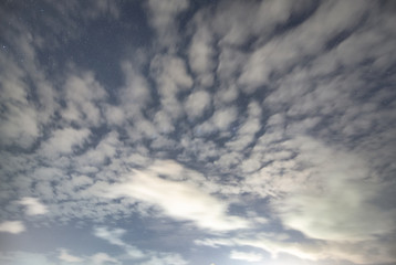 Cloudy sky with stars at night