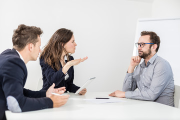 Angry female boss on a business meeting with her colleagues.