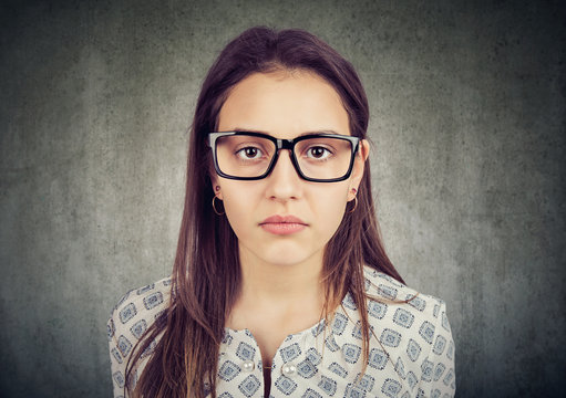 serious looking young woman in glasses