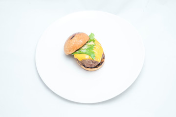Hamburger sandwich with cheese, vegetables and sausage