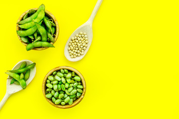 Green soybeans background on yellow desk top view mockup
