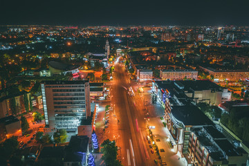 Obraz premium Aerial view of night city Voronezh downtown with illuminated buildings, malls, roads with car traffic, drone photo