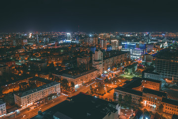Obraz premium Aerial panoramic view from drone above night city Voronezh downtown and historical center with illuminated roads and modern high-rise buildings