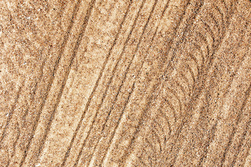 Yellow sand tyre mark shape lines pattern.