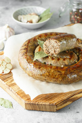 baked homemade sausage with spices and herbs, close up. Spiral grilled  sausage.