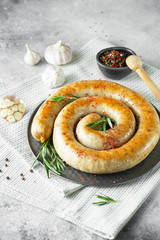 baked homemade sausage with spices and herbs. Spiral grilled homemade sausage.