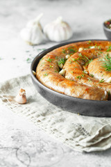 baked homemade sausage with spices and herbs. Spiral grilled homemade sausage.