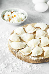 uncooked cottage cheese dumplings on a board