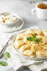 Dumplings, filled with cottage cheese. Russian, Ukrainian or Polish dish varenyky, vareniki, pierogi, pyrohy.